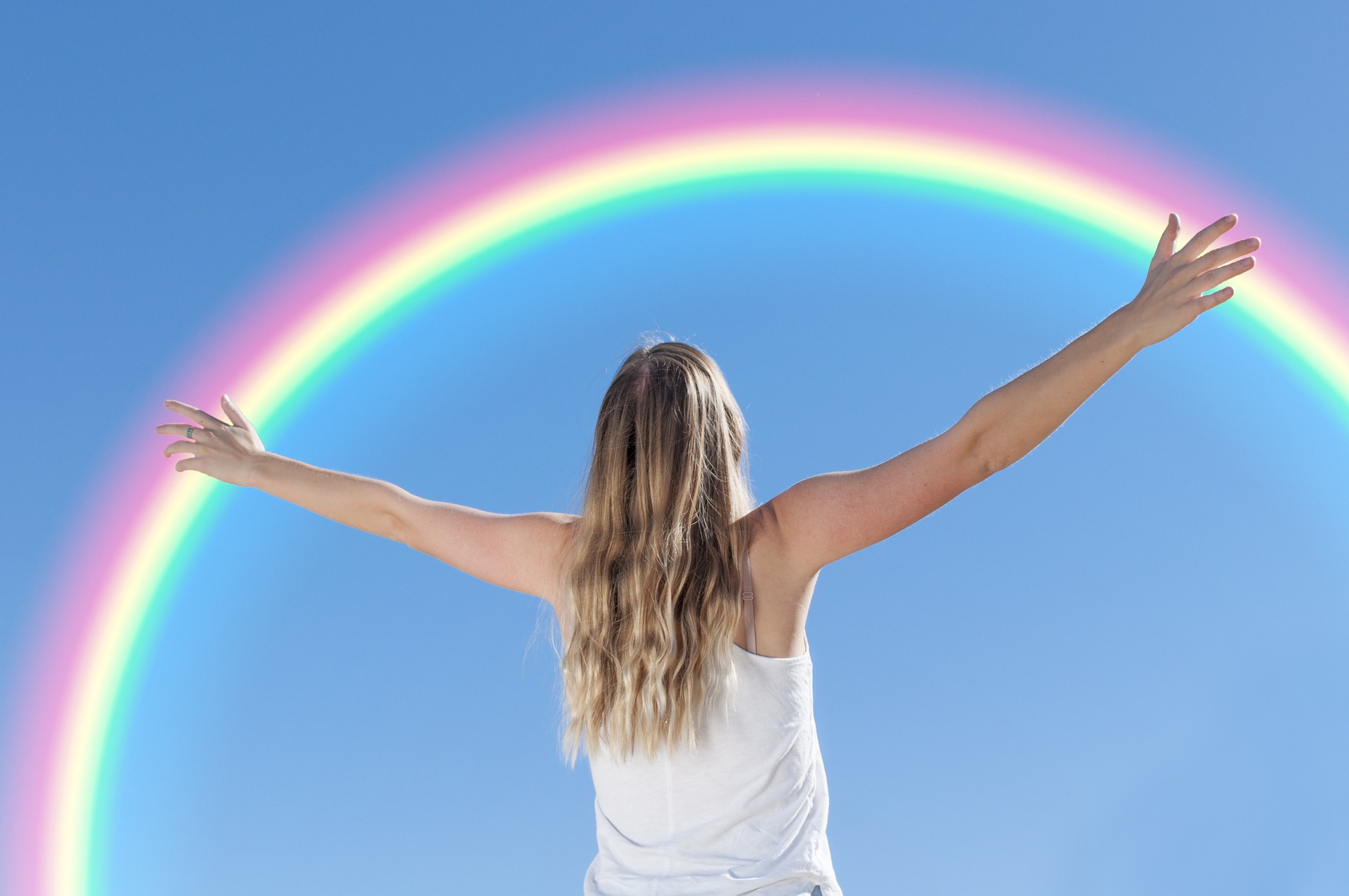 Woman celebrating a rainbow - expat ;ife