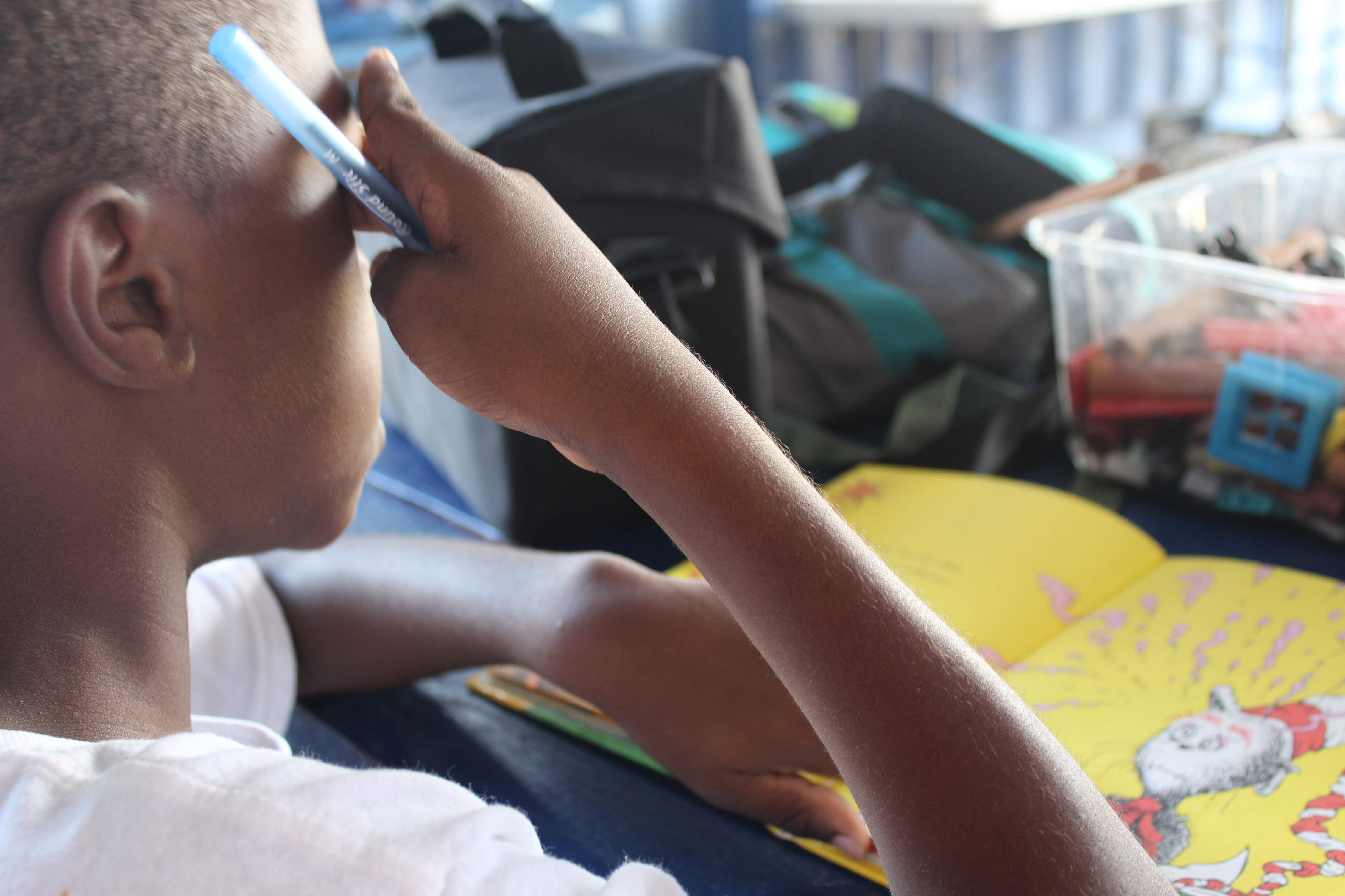 Teaching is a popular voluntourism activity. Here we see a child doing homework. Photo:  Breana Johnson