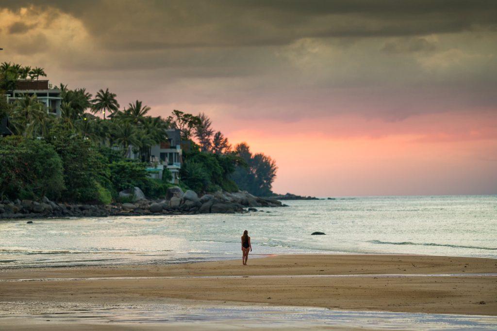 Travel - Lone girl on beach during sunset
