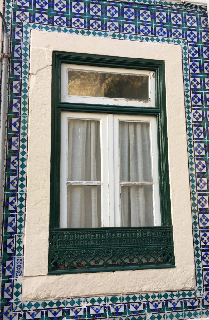 Portugal is famous for its blue tiles. The blue tiles that wrap this apartment window is very common. Photo: Manali Shah