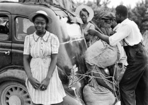 African American family packing their car to migrate to the North.