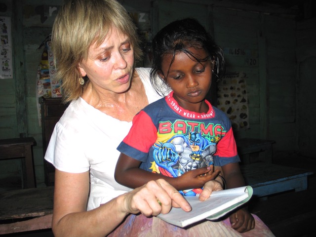 The author helping a student with her English lesson. Photo: Tim Leland
