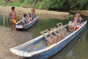 Family on a wooden longboat in Panama. Photo: Chez