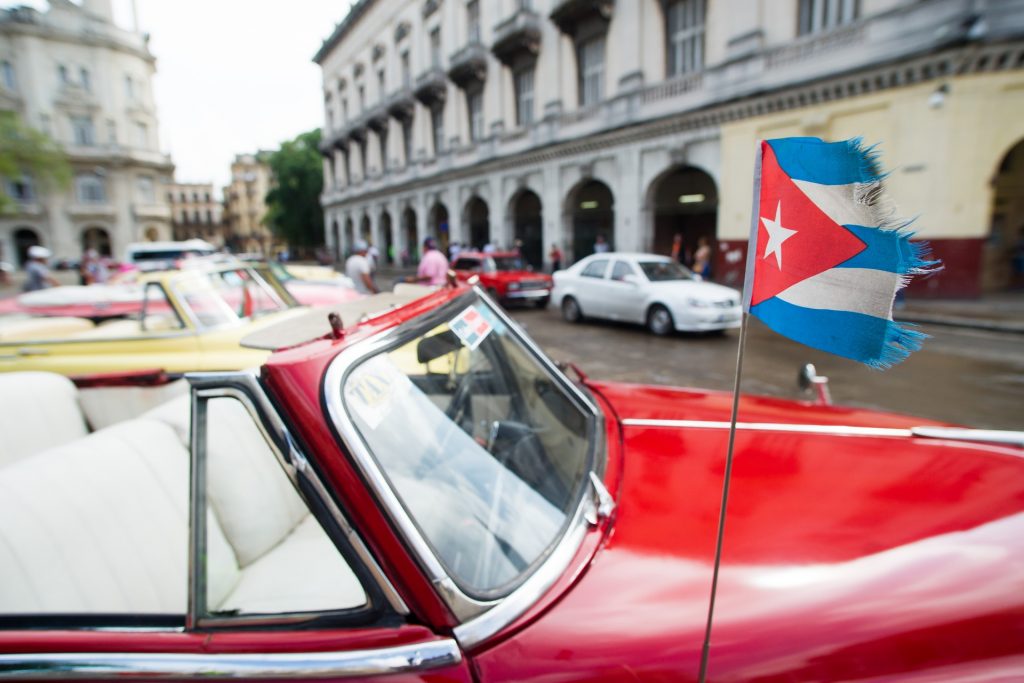 Cuba | Cuban car with flag in Havana.