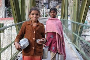 The two girls and their tiffin boxes on Gangotri's main (but totally tiny) bridge. Photo: Trixie Pacis