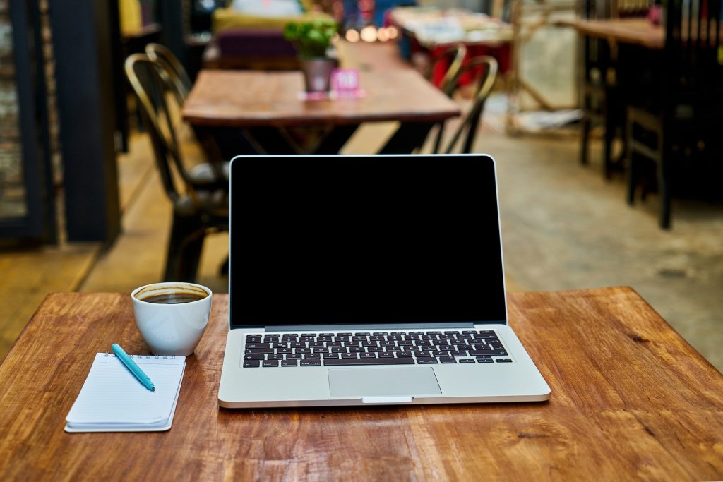 coffee laptop in cafe is the desk of a digital nomad