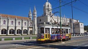 A tram traveling down a street in Portugal's capital, Lisbon.