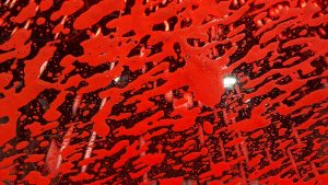 Red soap in a car wash