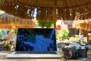 Computer and camera on travel. Remote work
