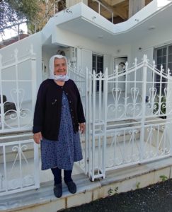 Greek woman standing in front of her house. Photo: Jim Bamboulis