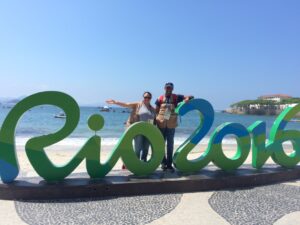 Tonya and Ian in Rio de Janeiro covering the 2016 Paralympic Games. Rio 2016 sign is on Copacabana Beach.
