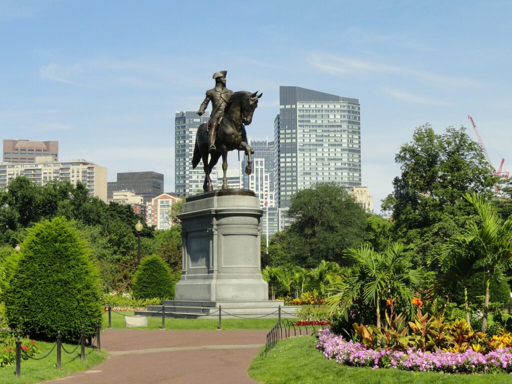 Statue of Paul Revere with the Boston skyline behind.