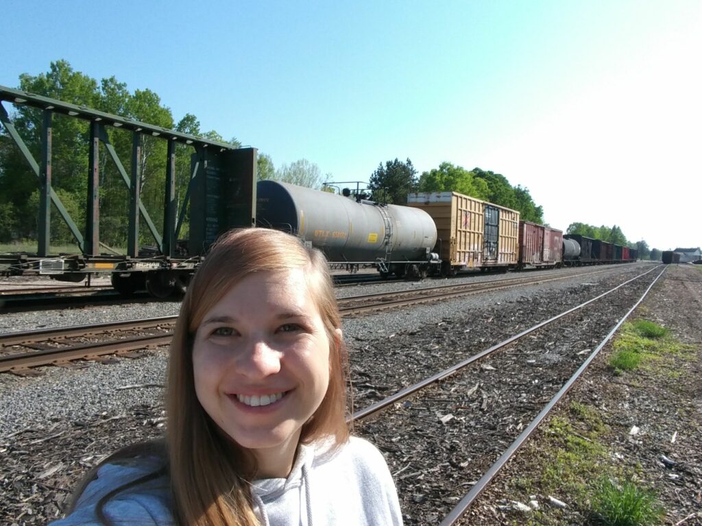 Author taking selfie with trains in Trout Lake, Michigan.
