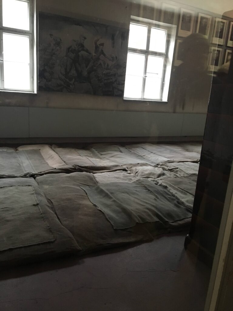 Straw mats served as beds in Auschwitz. Photo by Rachel Flynn