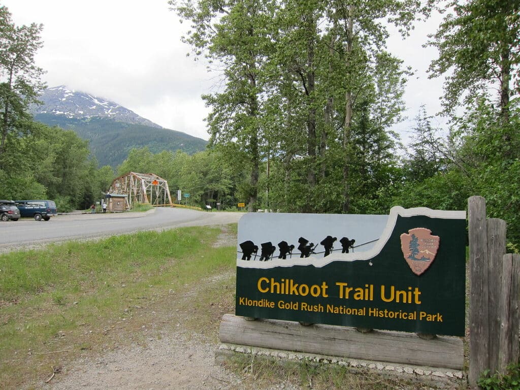 Chilkoot trail park sign.jpg" by Phillip Stewart is licensed under CC BY-SA 2.0 