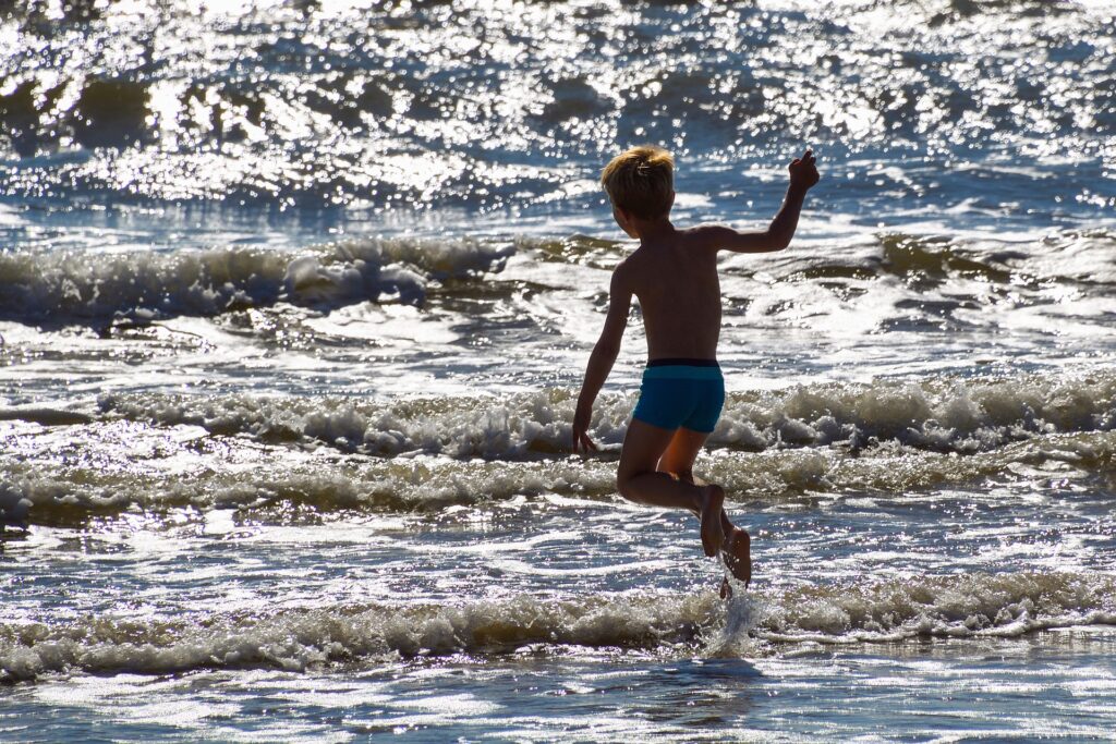 boy-jumping-waves