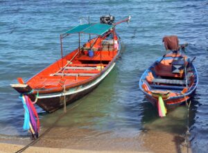Long boats on Mae Haad beach in Koh Phangan, Thailand.