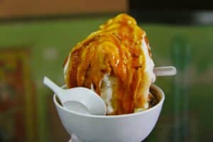 Cendol is an iced sweet dessert that contains droplets of green rice flour jelly, coconut milk and palm sugar syrup.