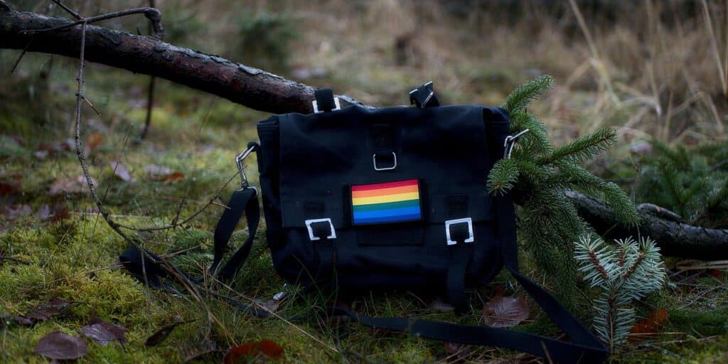 Bag-with-gay-pride-flag-in-a-forest-setting