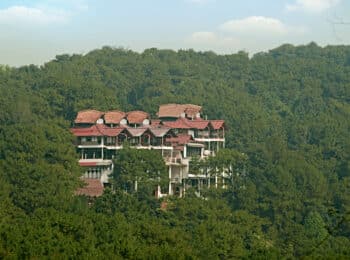 Meghalaya - Ri Kynjai is built into the forested slopes of a hill adjacent to the lake