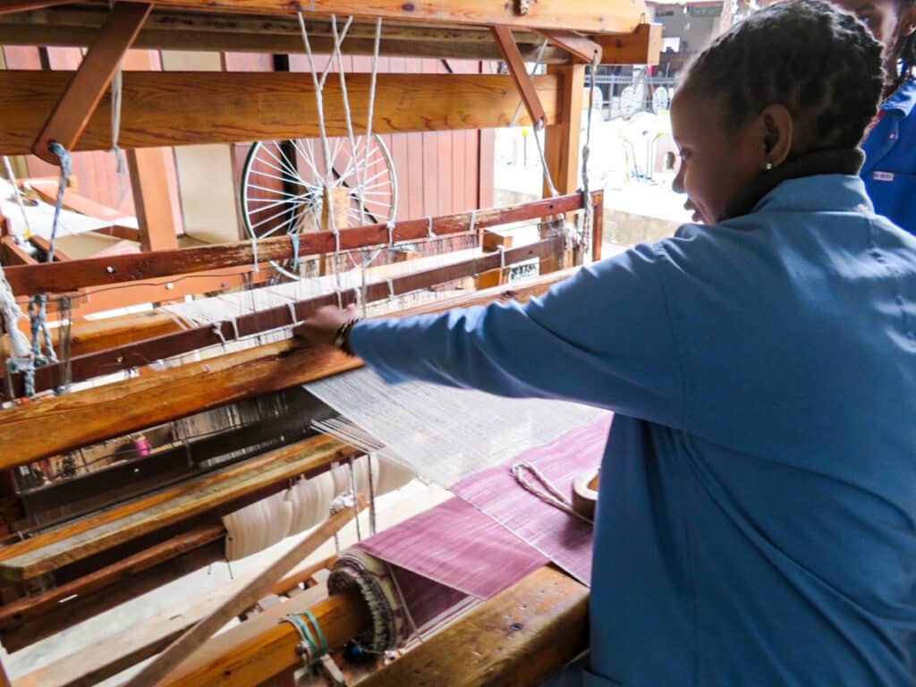 Working the loom. Photo: Margaret Timberlake