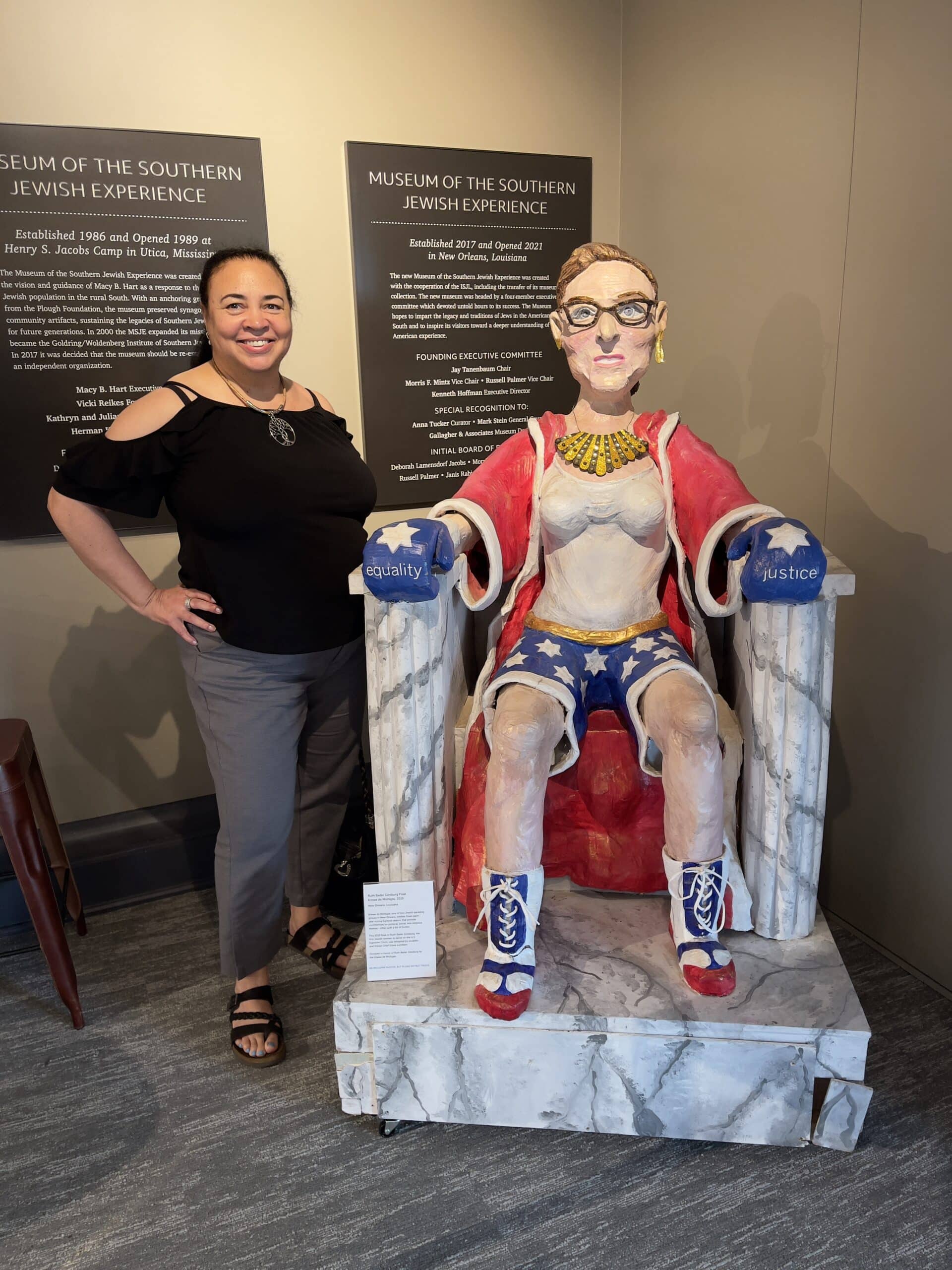 Tonya standing at Ruth Bader Ginsburg (RBG) statue in the Museum of the Southern Jewish Experience.