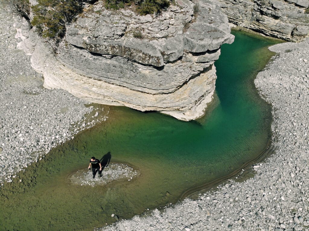 Author walking through shallow waters at the entrance of Osum Canyon