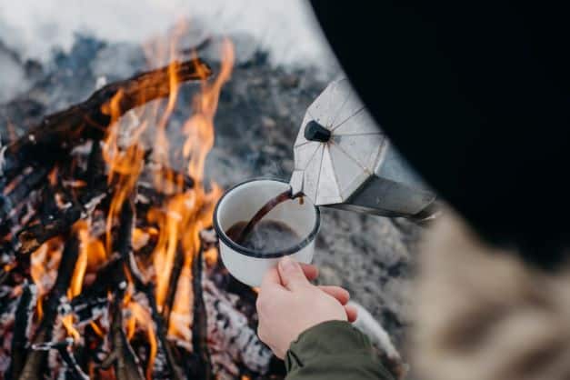 Coffee over outdoor fire while winter camping