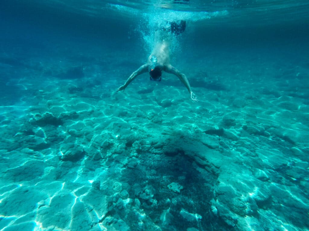 Author jumping into the clear waters at the Ayia Napa Sea Caves. Courtesy Thomas Später