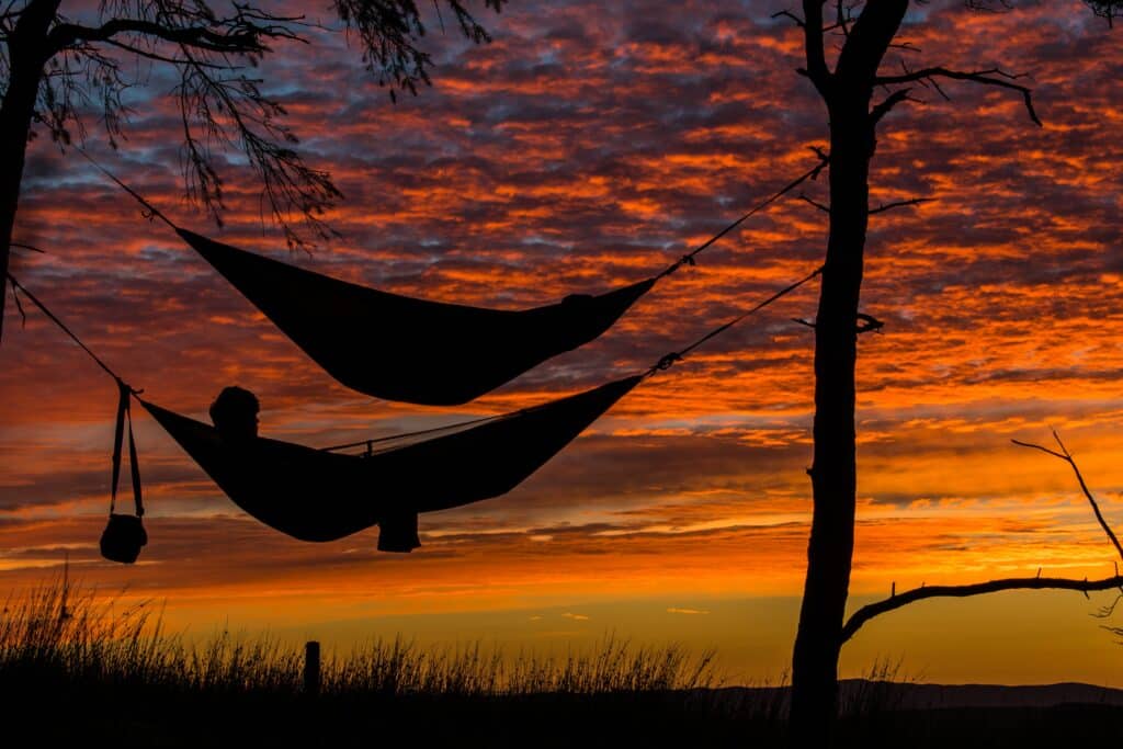 Person-lying-in-hammock-at-sunset-photo-by-chris-thompson-unsplash