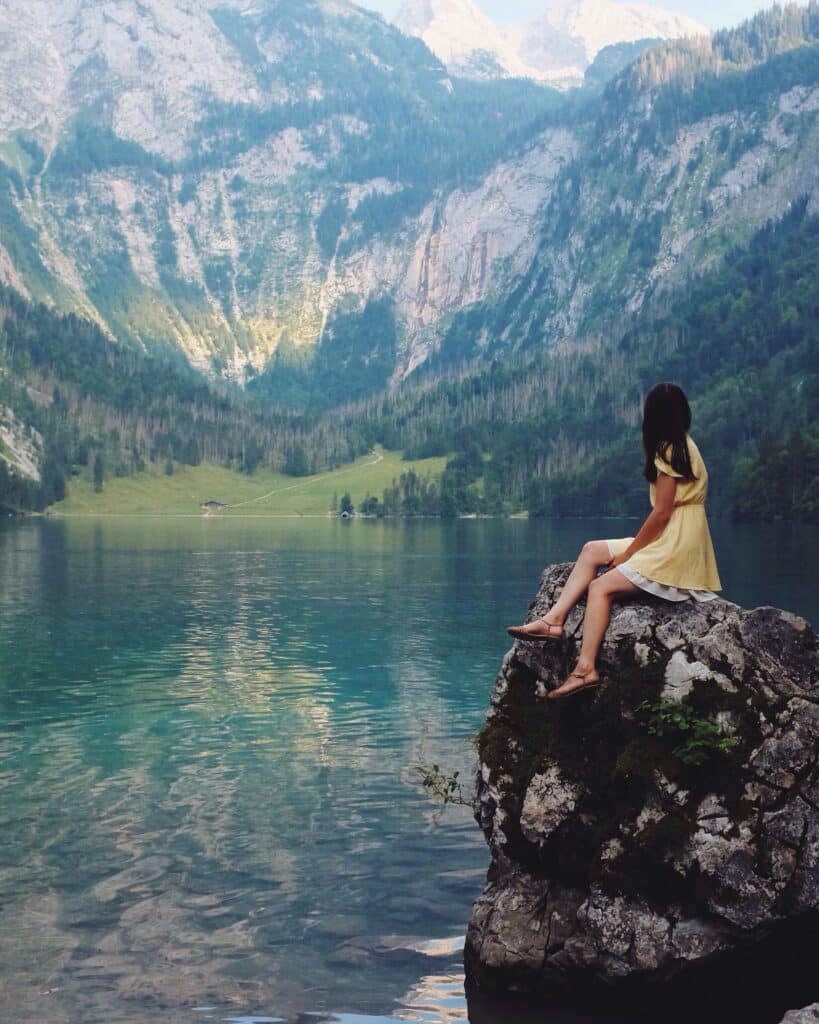 nadi-whatis-photo-Woman-sitting-on-rock-near-lake-unsplash.Vacation Spots