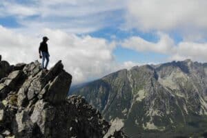 1 Author overlooking the High Tatras Mountains from a sharp rock scaled