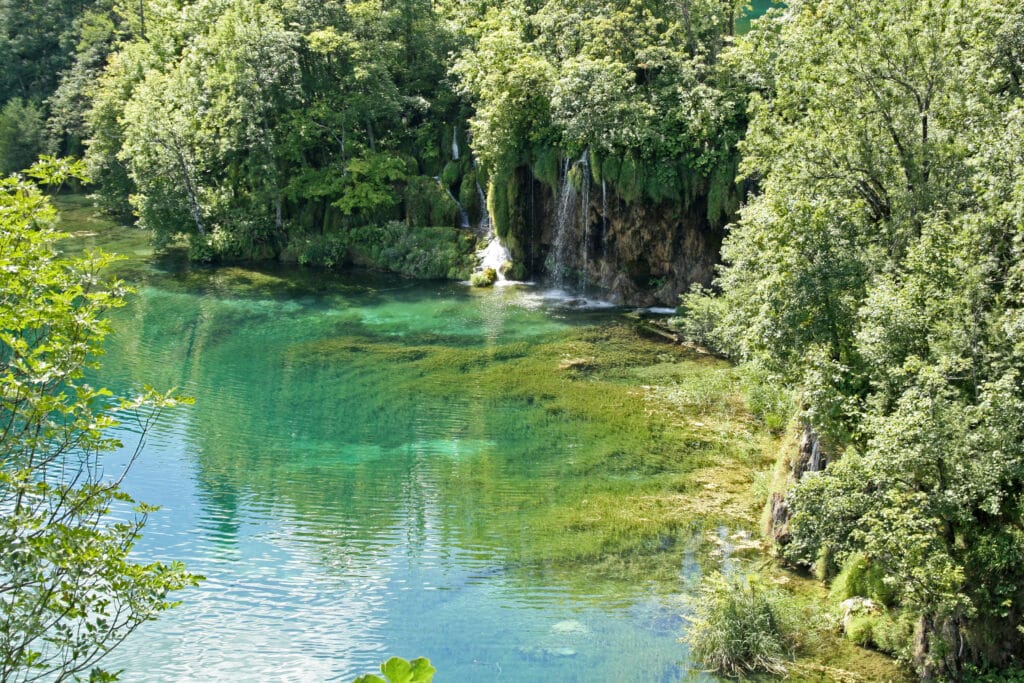 6 Picturesque scenery of small waterfalls dropping into crystal clear lake of Plitvice National Park