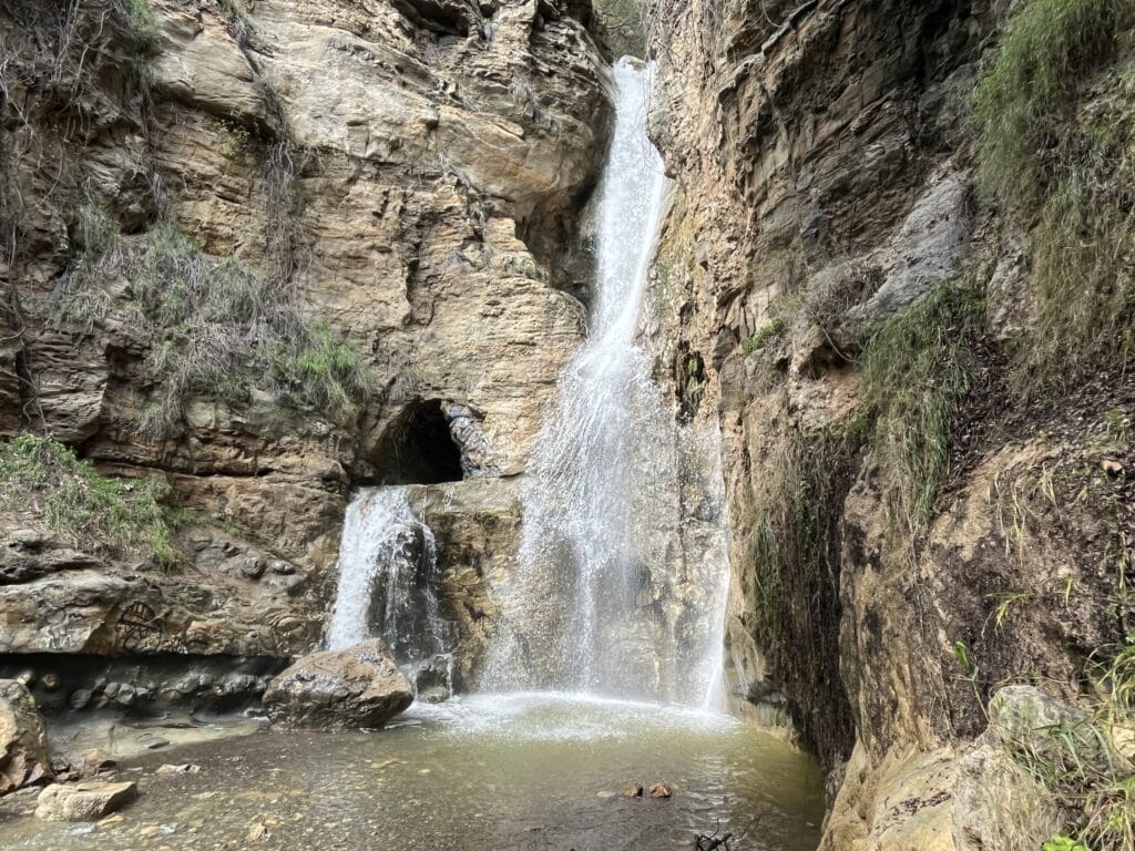 Black Star Canyon Falls with smaller waterfall and cave to the left after heavy rainfall